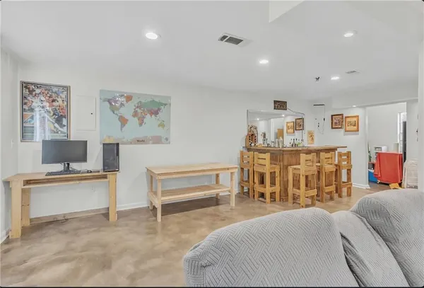 a view of a kitchen with furniture and wooden floor