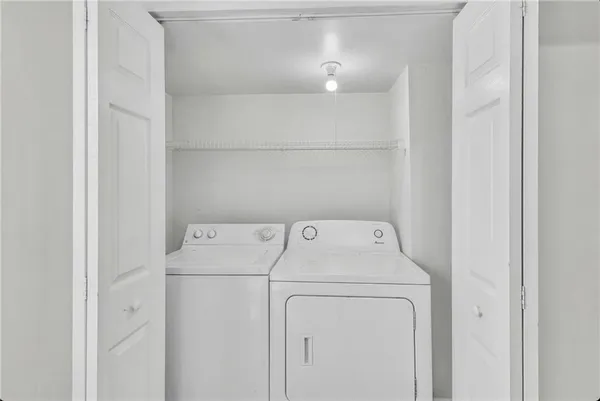 a view of a big room with wooden floor and windows
