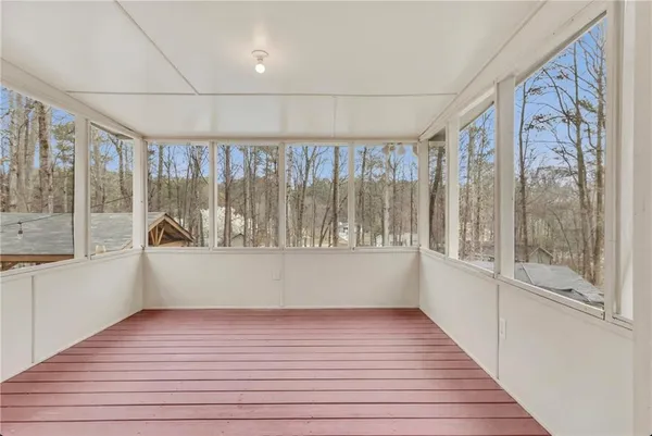 a view of a patio with table and chairs potted plants and a large tree