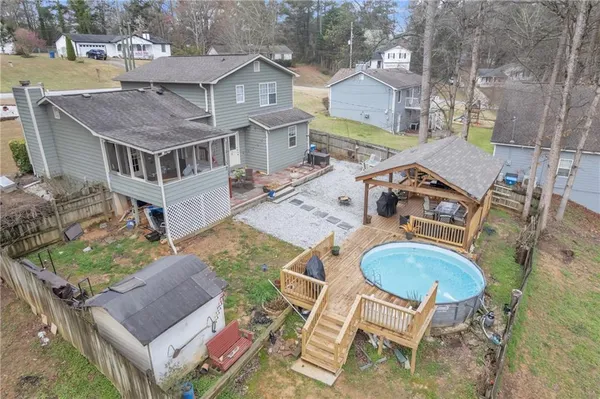 a view of a patio with table and chairs potted plants