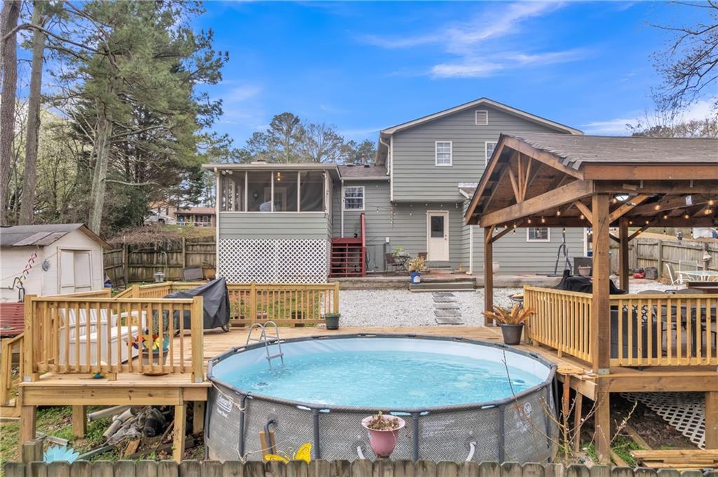 3123 Booths Court Dacula, GA 30019 - Photo 43 of 56 a view of a house with wooden deck and furniture
