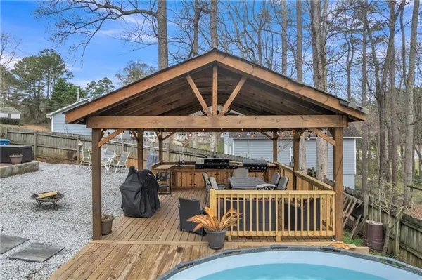 a view of a patio with couches chairs and a wooden floor