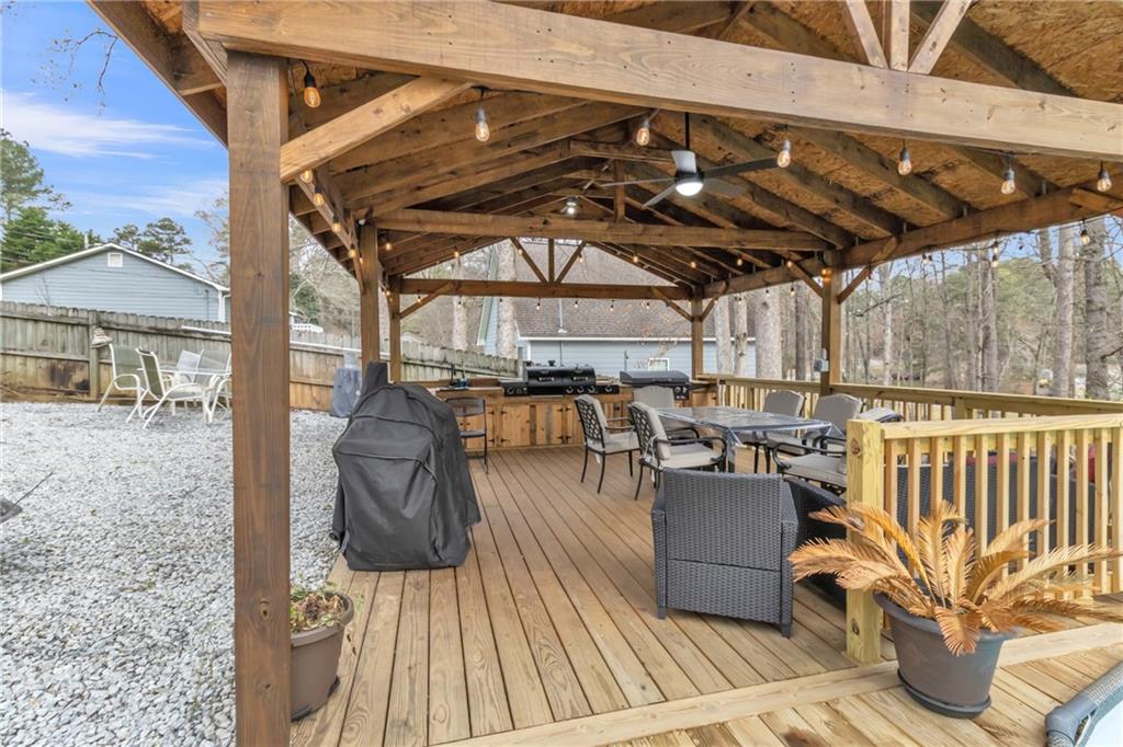 3123 Booths Court Dacula, GA 30019 - Photo 49 of 56 a view of a patio with couches chairs and a wooden floor
