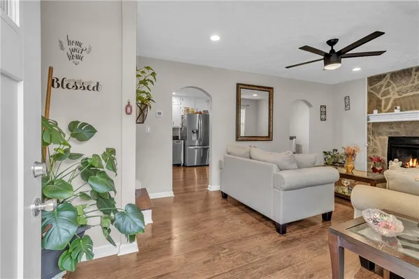a living room with furniture and a potted plant