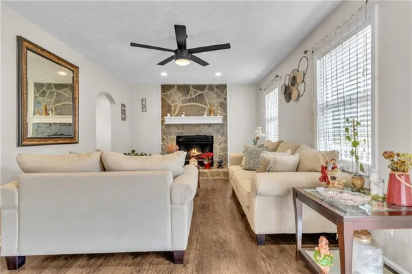 a living room with furniture and a fireplace