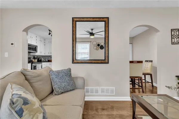 a living room with furniture and a painting
