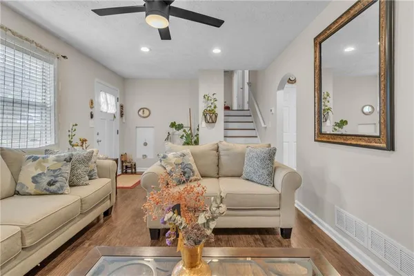 a living room with furniture and a chandelier