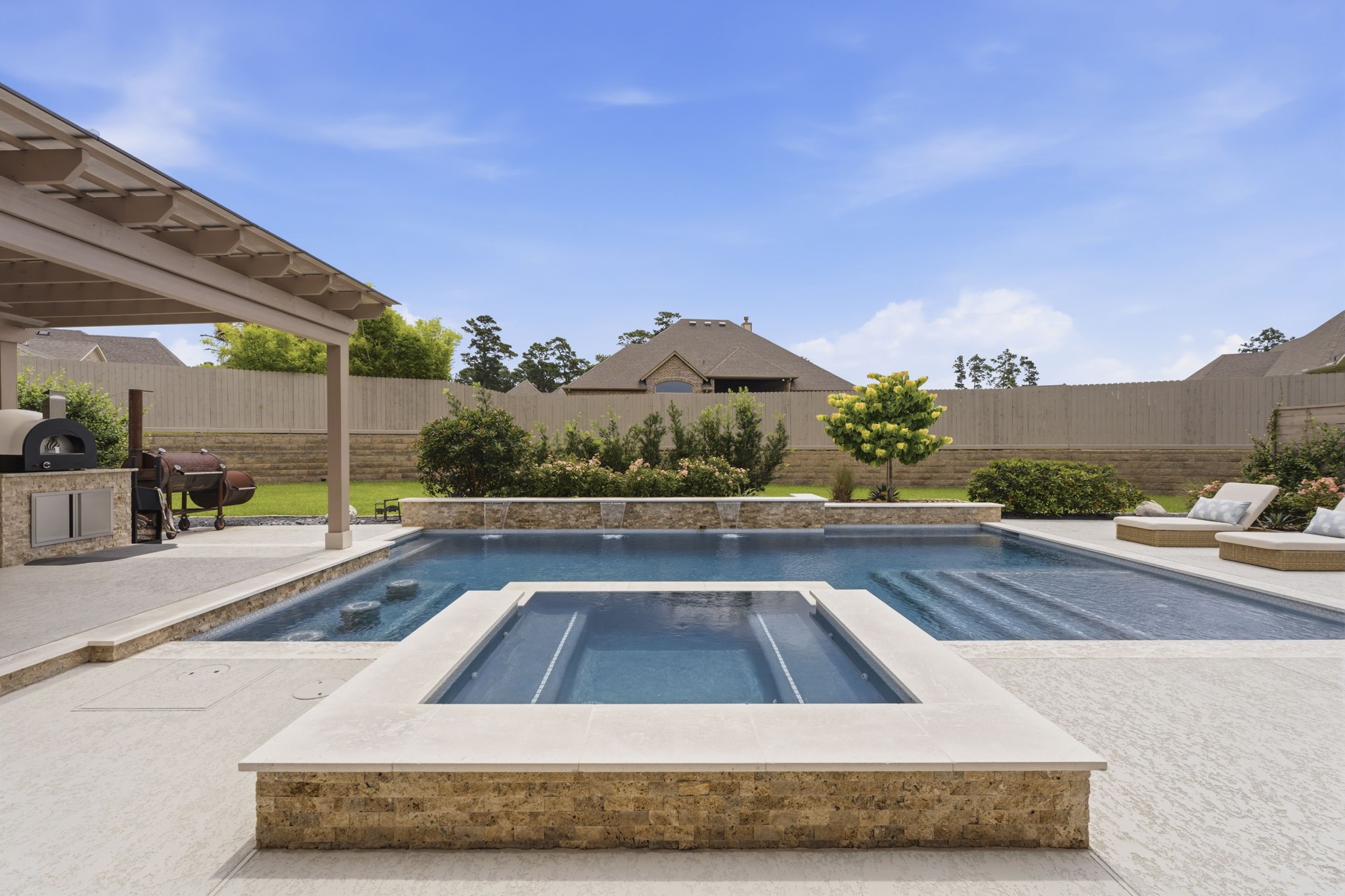 14012 Beartooth Bend Trail Conroe, TX 77384 - Photo 45 of 50 For the chilly winter Texas nights, the heated spa boasts plenty of seating and an infiniti edge. Not only does this backyard retreat offer a magnificent pool, spa, and outdoor kitchen, there is plenty of lawn for fun in the sun.