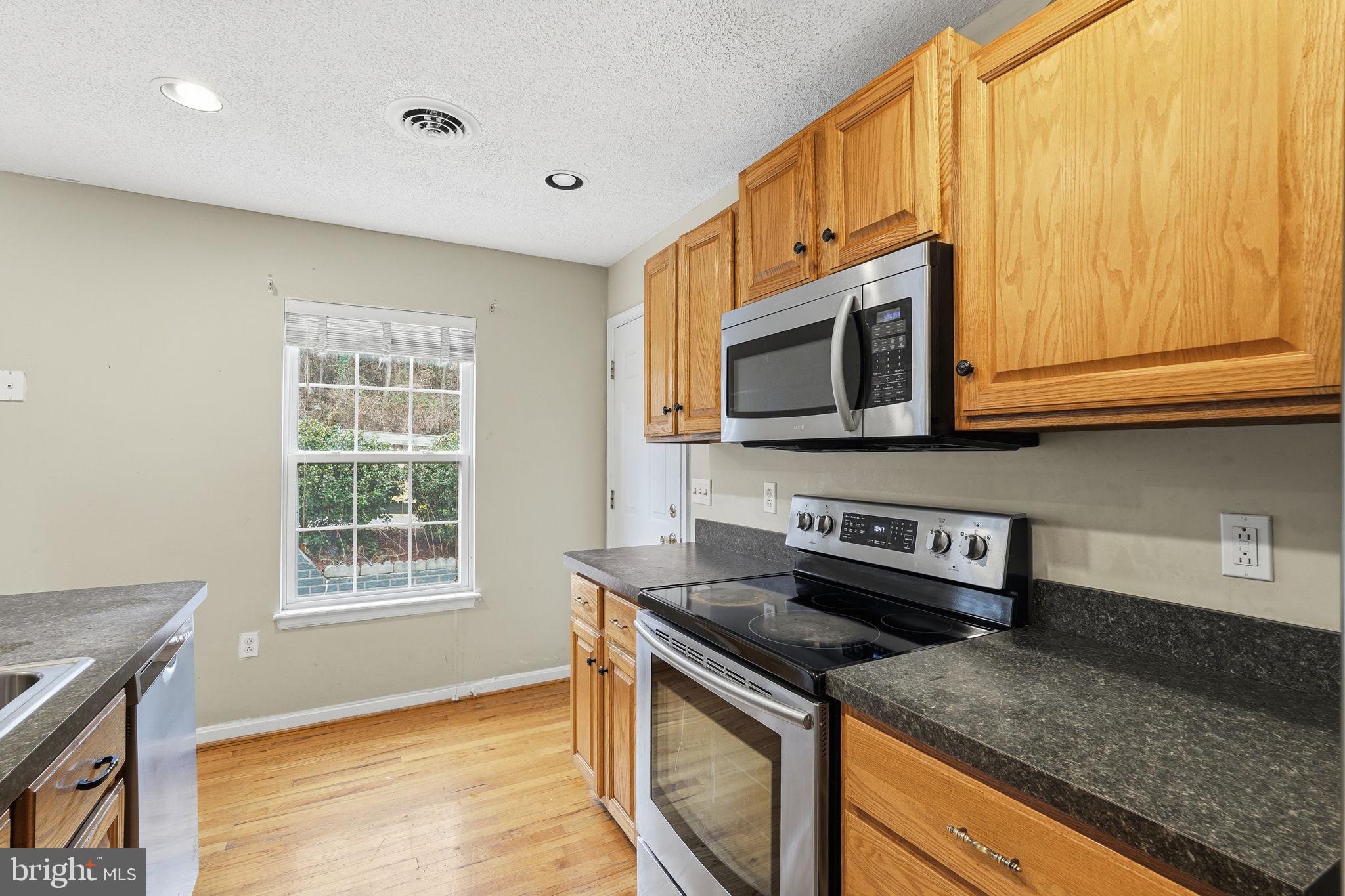 110 Rugby Place Winchester, VA 22603 - Photo 12 of 41 a kitchen with stainless steel appliances granite countertop a stove a microwave and a sink