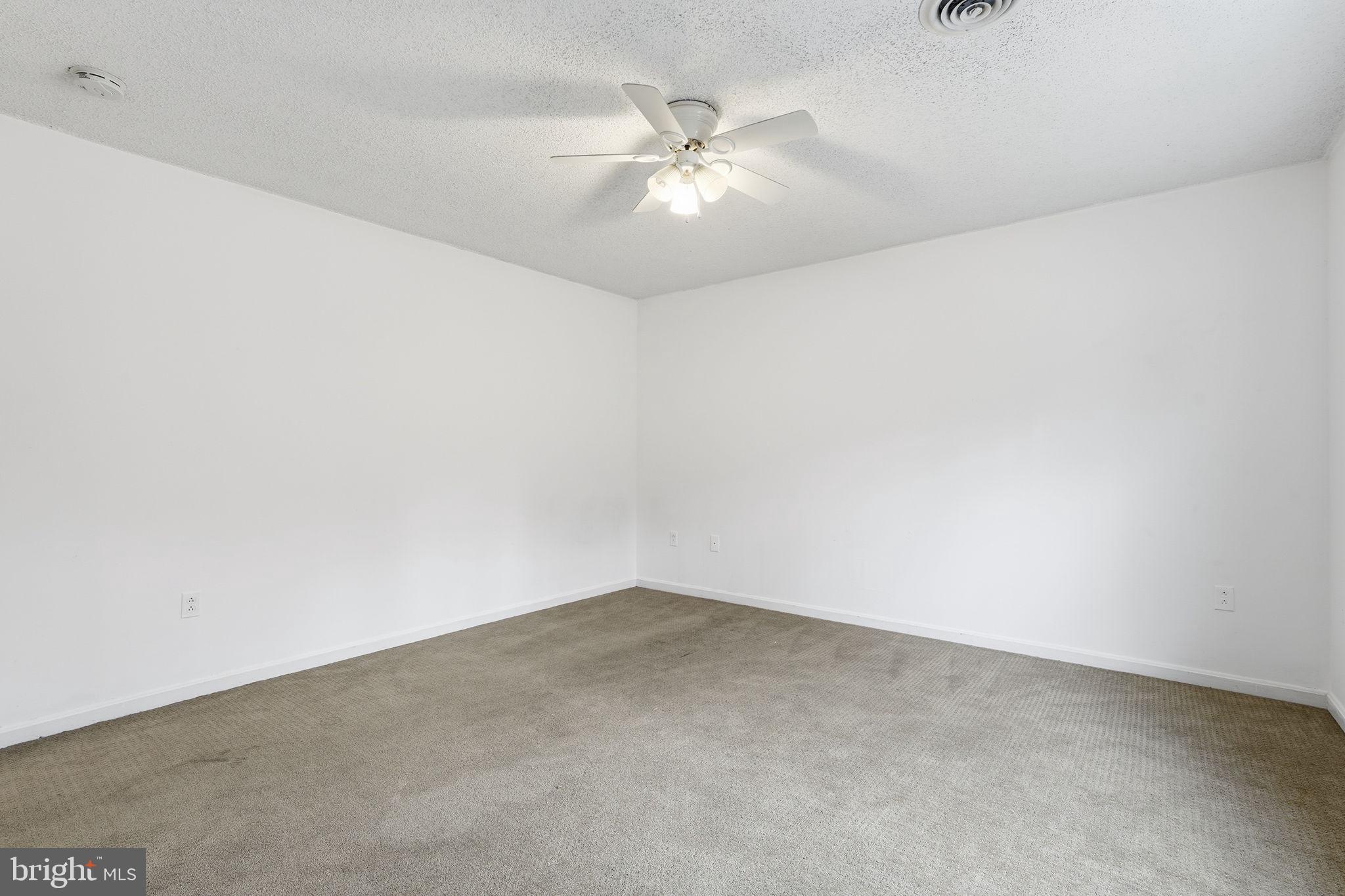 110 Rugby Place Winchester, VA 22603 - Photo 24 of 41 an empty room with a chandelier fan and windows
