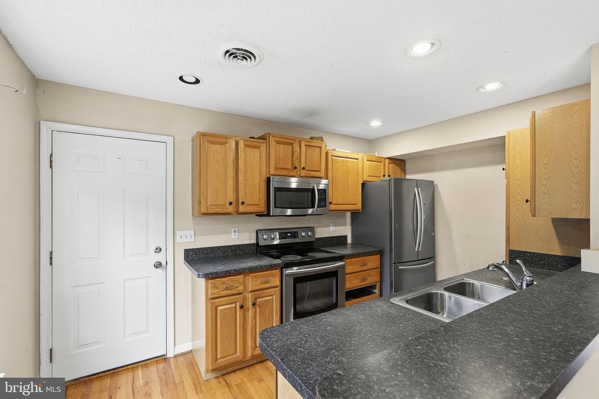110 Rugby Place Winchester, VA 22603 - Photo 7 of 41 a kitchen with stainless steel appliances granite countertop a refrigerator stove and sink