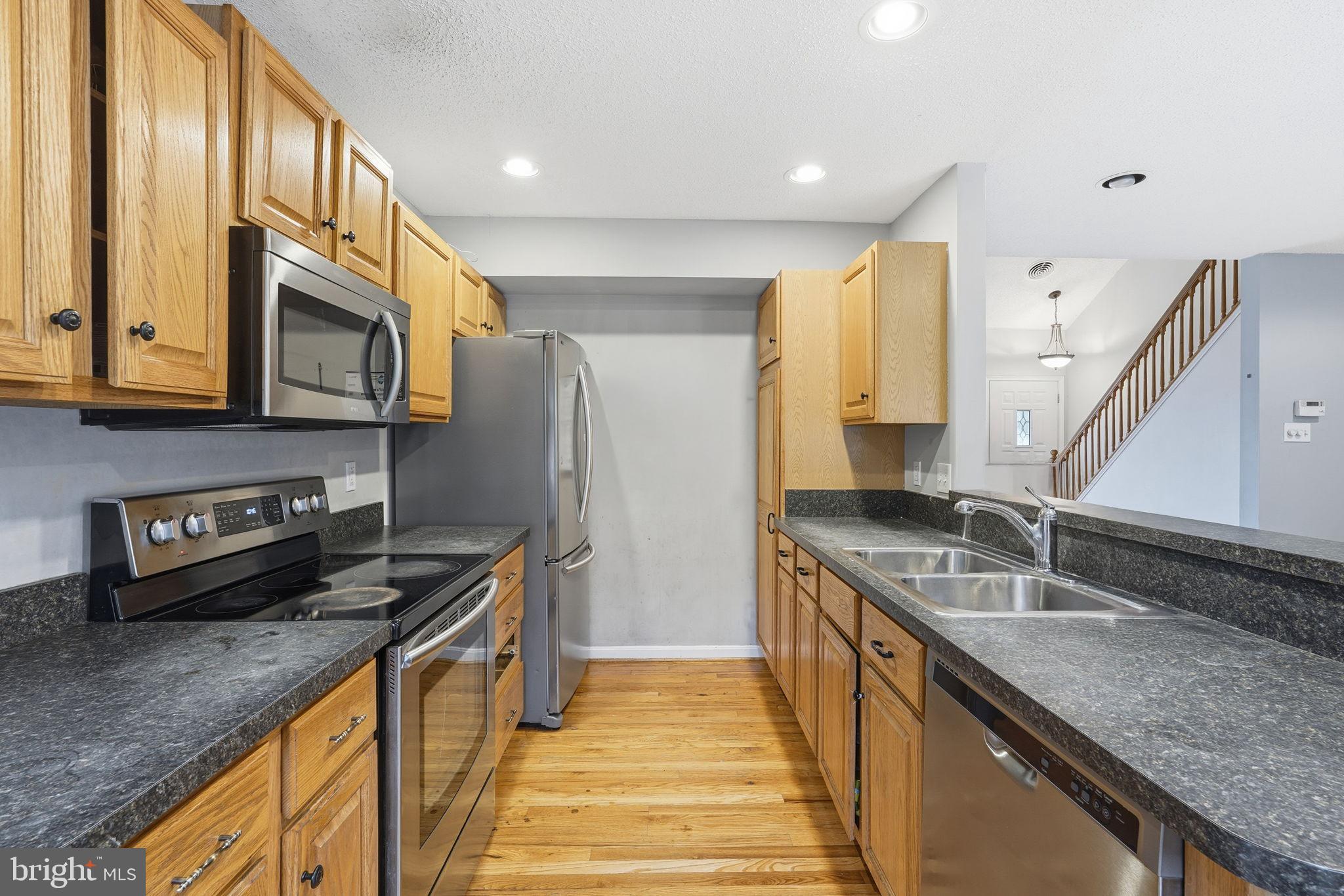 110 Rugby Place Winchester, VA 22603 - Photo 10 of 41 a kitchen with stainless steel appliances granite countertop a sink a stove and a refrigerator