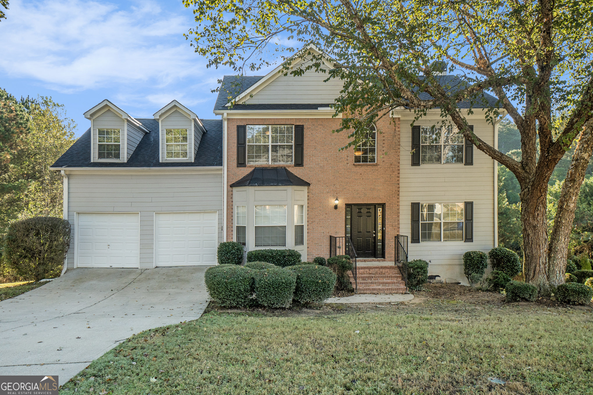 4395 Celebration Drive Southwest Atlanta, GA 30331 - Photo 1 of 25 a front view of a house with a yard and garage
