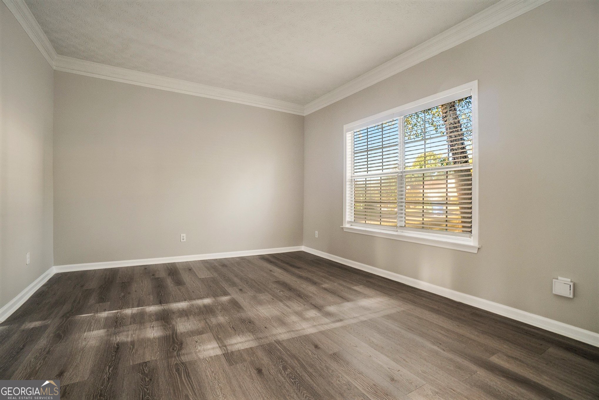 4395 Celebration Drive Southwest Atlanta, GA 30331 - Photo 12 of 25 a view of an empty room with wooden floor and a window