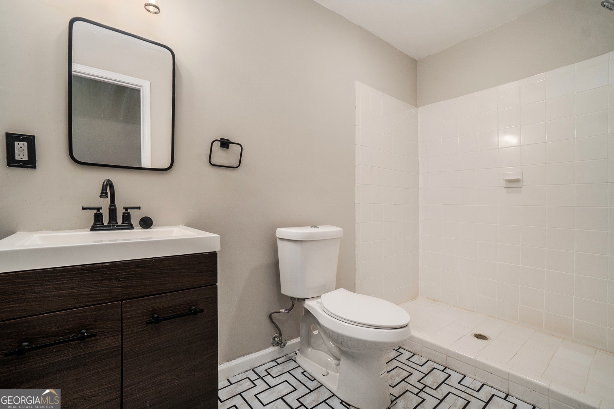 4395 Celebration Drive Southwest Atlanta, GA 30331 - Photo 20 of 25 a bathroom with a toilet a sink a mirror and vanity