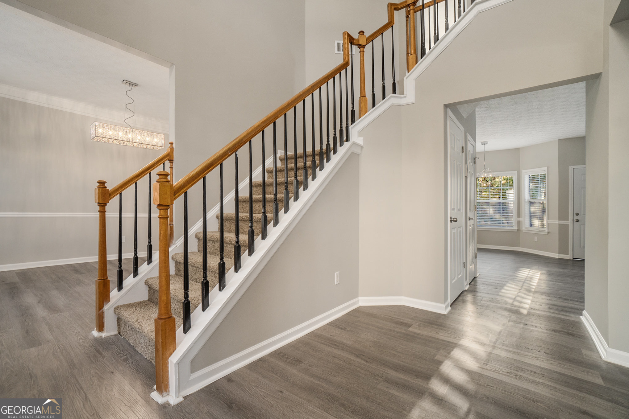 4395 Celebration Drive Southwest Atlanta, GA 30331 - Photo 4 of 25 a view of staircase with wooden floor and a rug