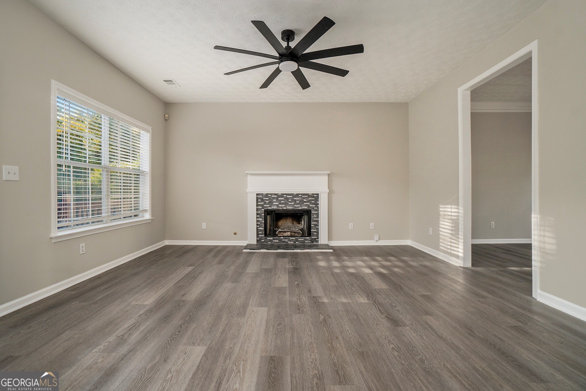 4395 Celebration Drive Southwest Atlanta, GA 30331 - Photo 6 of 25 wooden floor fireplace and windows in an empty room