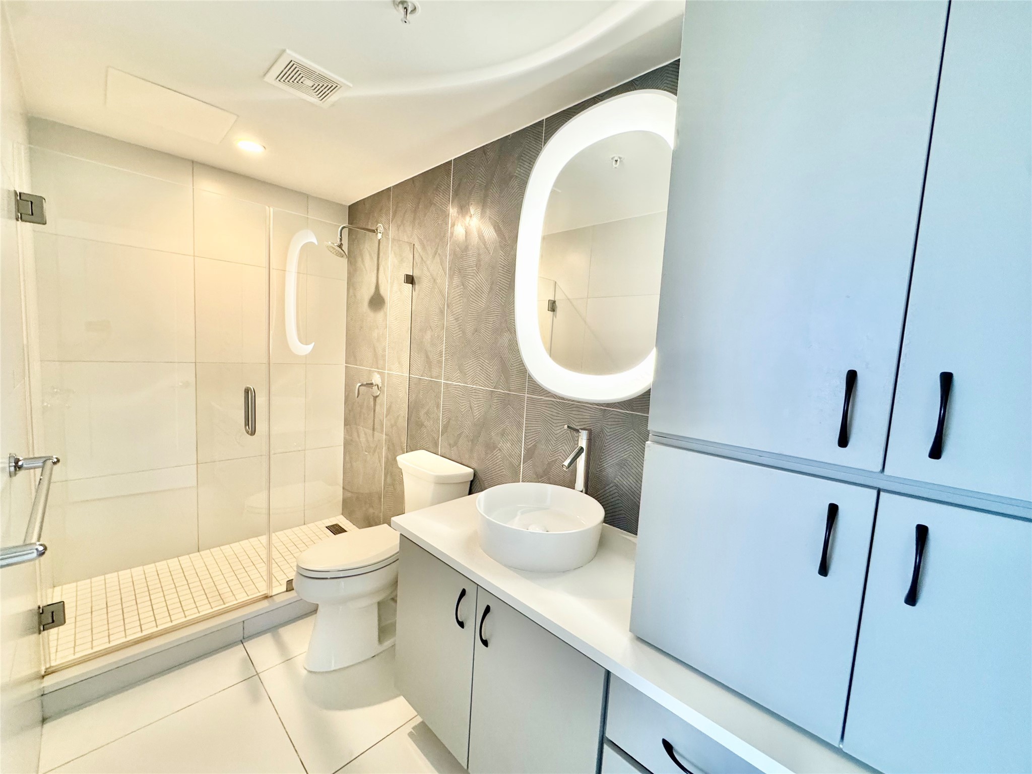 2201 Market Street, Unit 1101 Galveston, TX 77550 - Photo 12 of 12 a bathroom with a sink toilet and shower