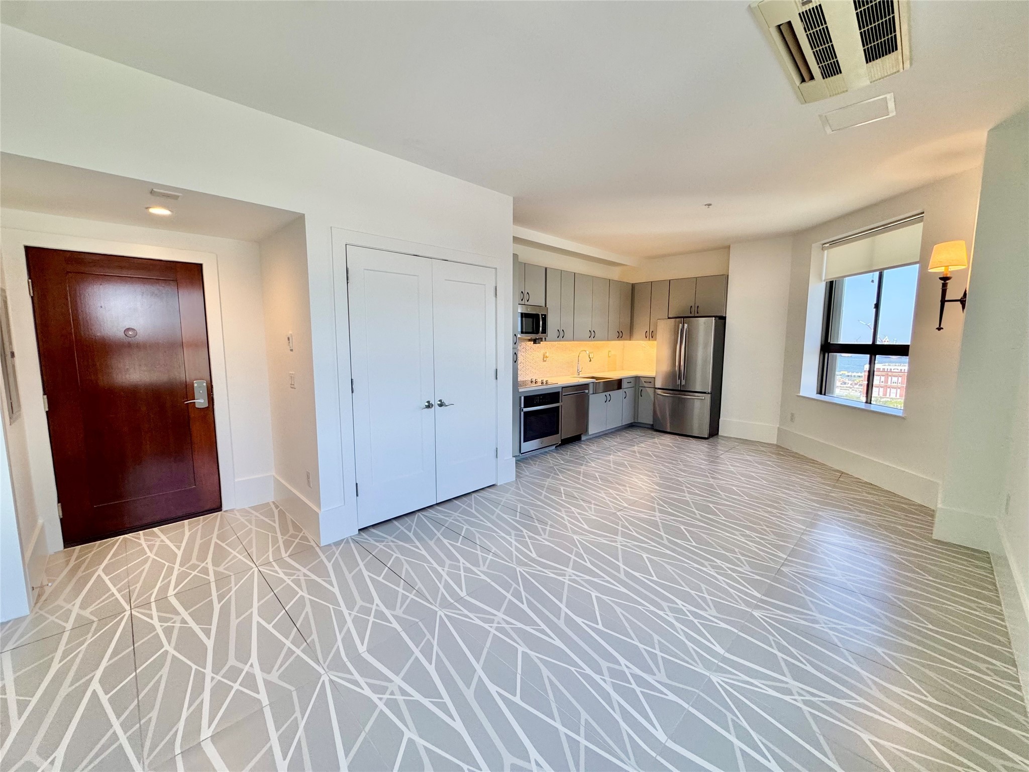 2201 Market Street, Unit 1101 Galveston, TX 77550 - Photo 2 of 12 a view of empty room with kitchen view and wooden floor