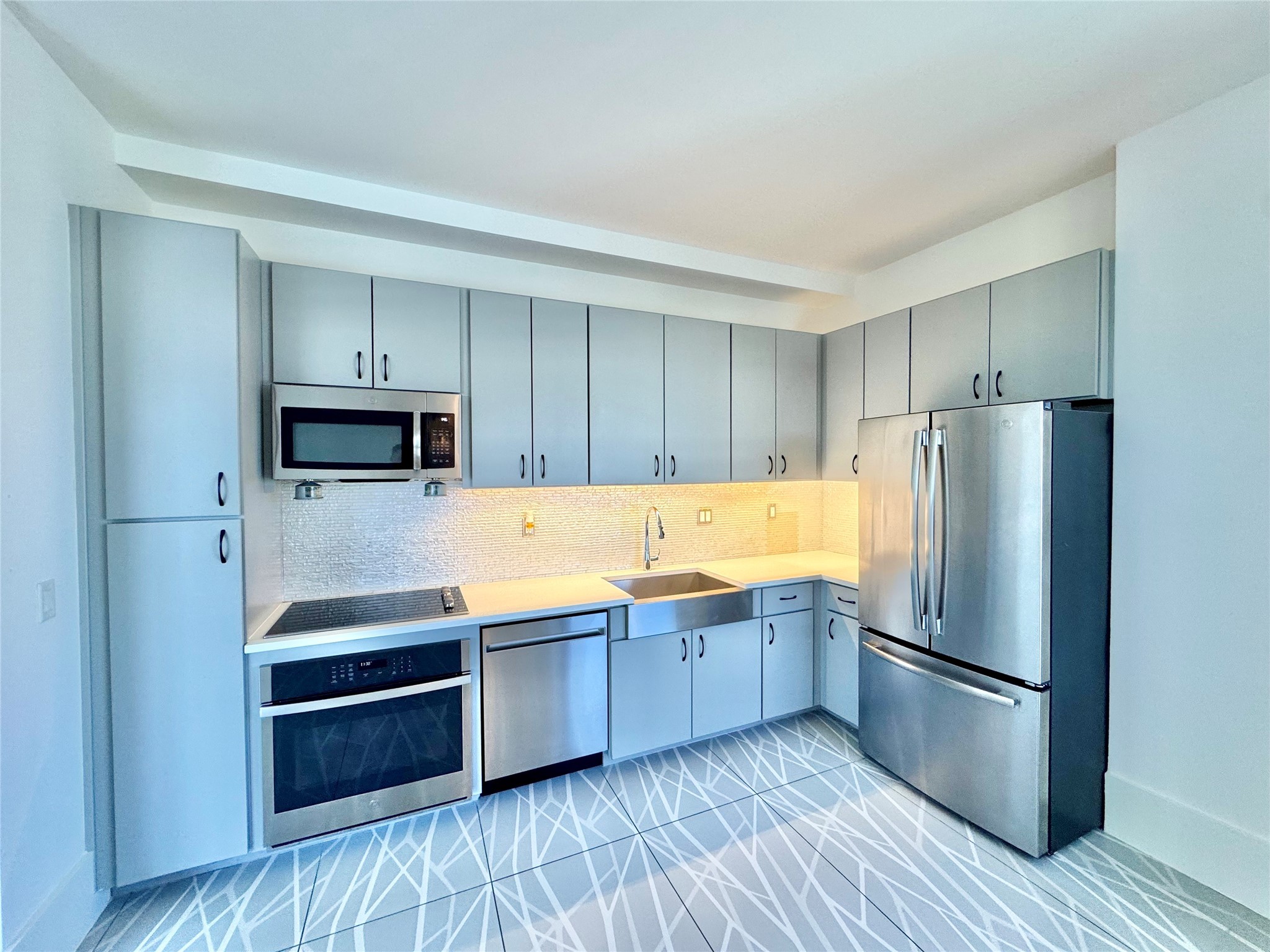 2201 Market Street, Unit 1101 Galveston, TX 77550 - Photo 3 of 12 a kitchen with stainless steel appliances a refrigerator and a stove top oven