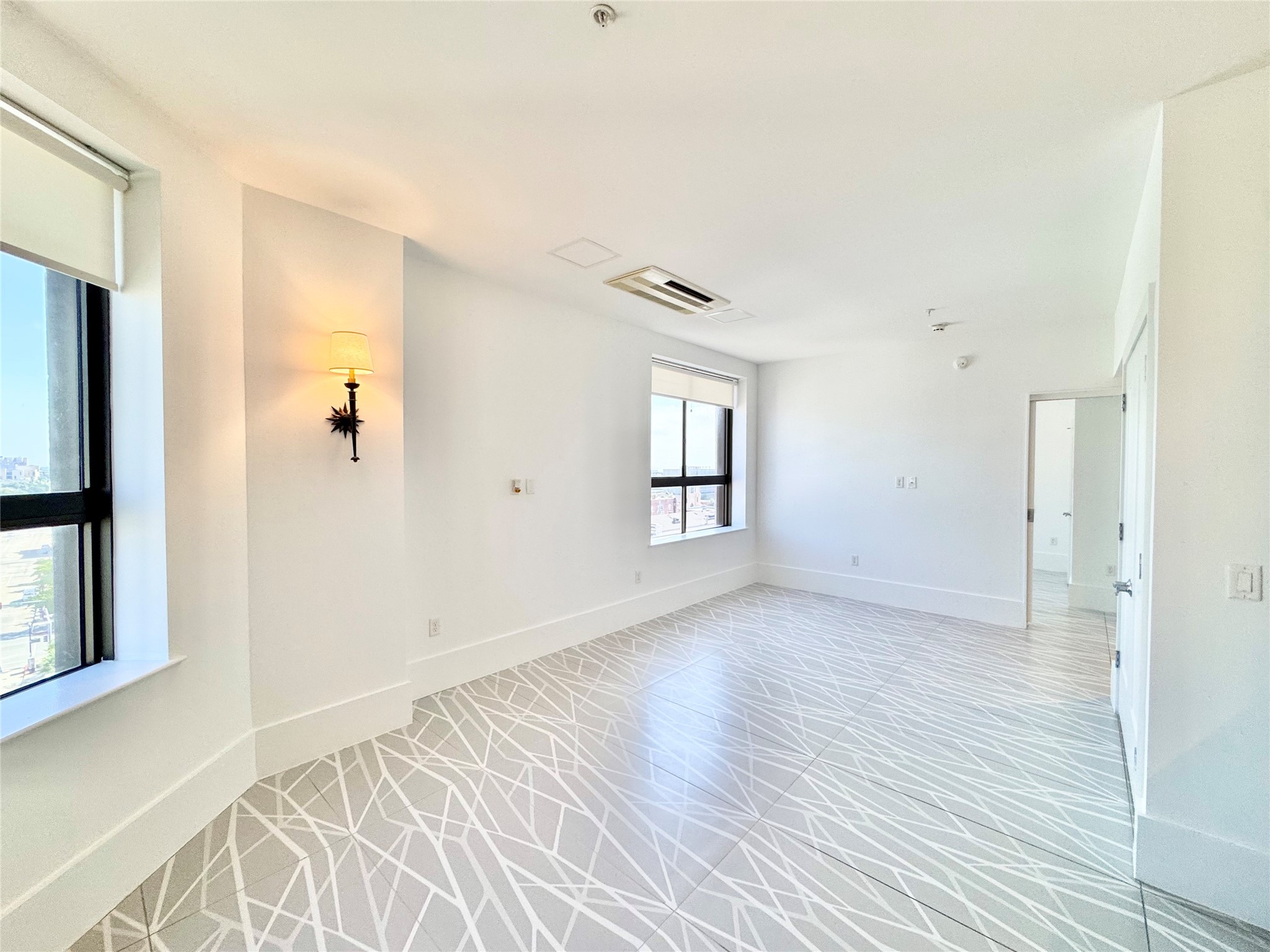2201 Market Street, Unit 1101 Galveston, TX 77550 - Photo 6 of 12 a view of a livingroom with wooden floor and a window