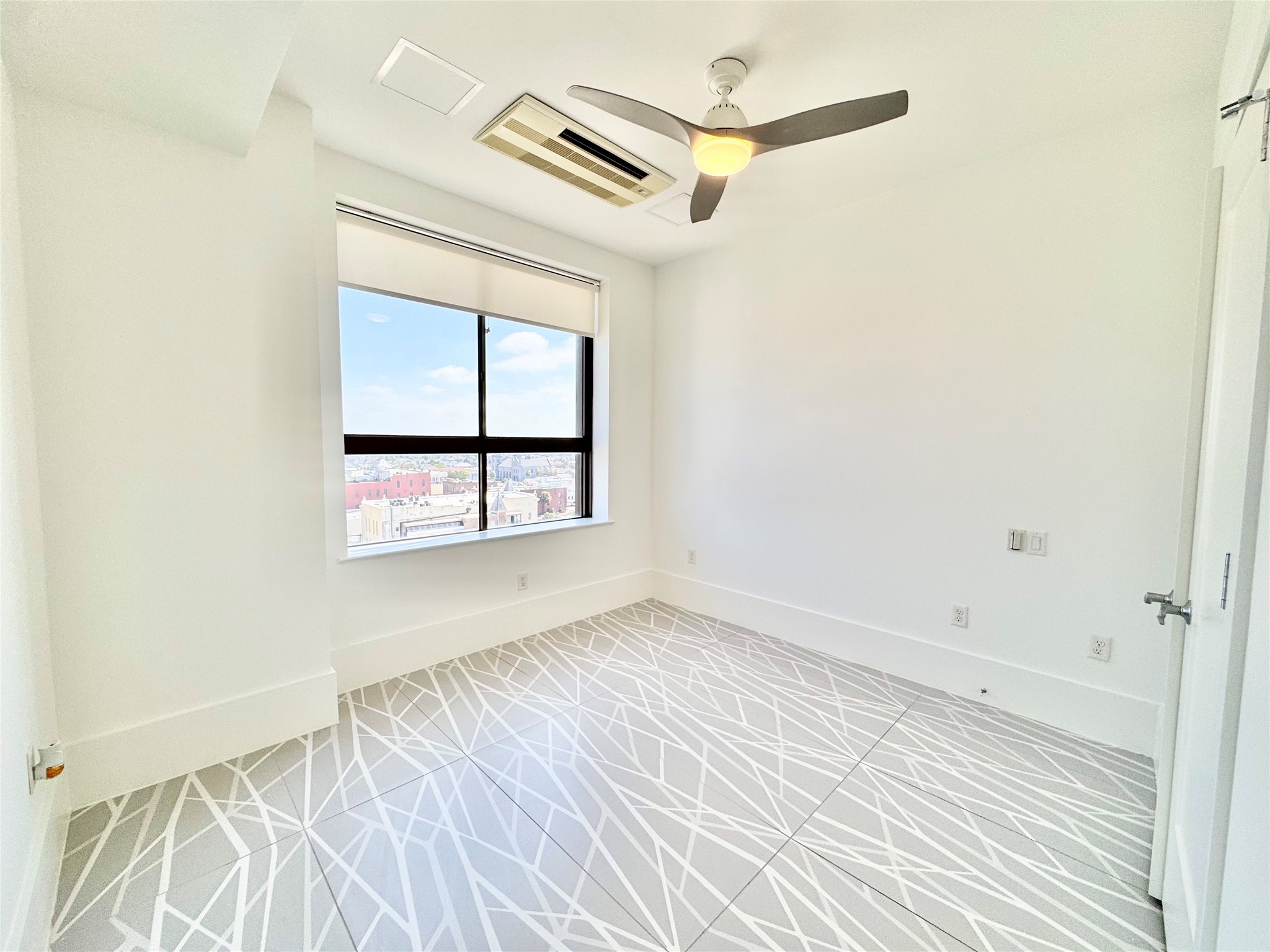 2201 Market Street, Unit 1101 Galveston, TX 77550 - Photo 9 of 12 an empty room with windows and closet