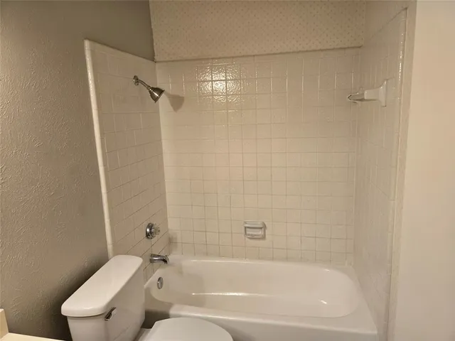 a bathroom with a bathtub and a toilet