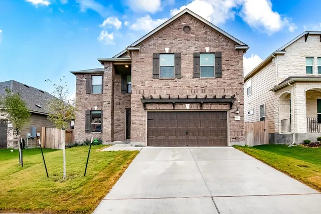 a front view of a house with a yard