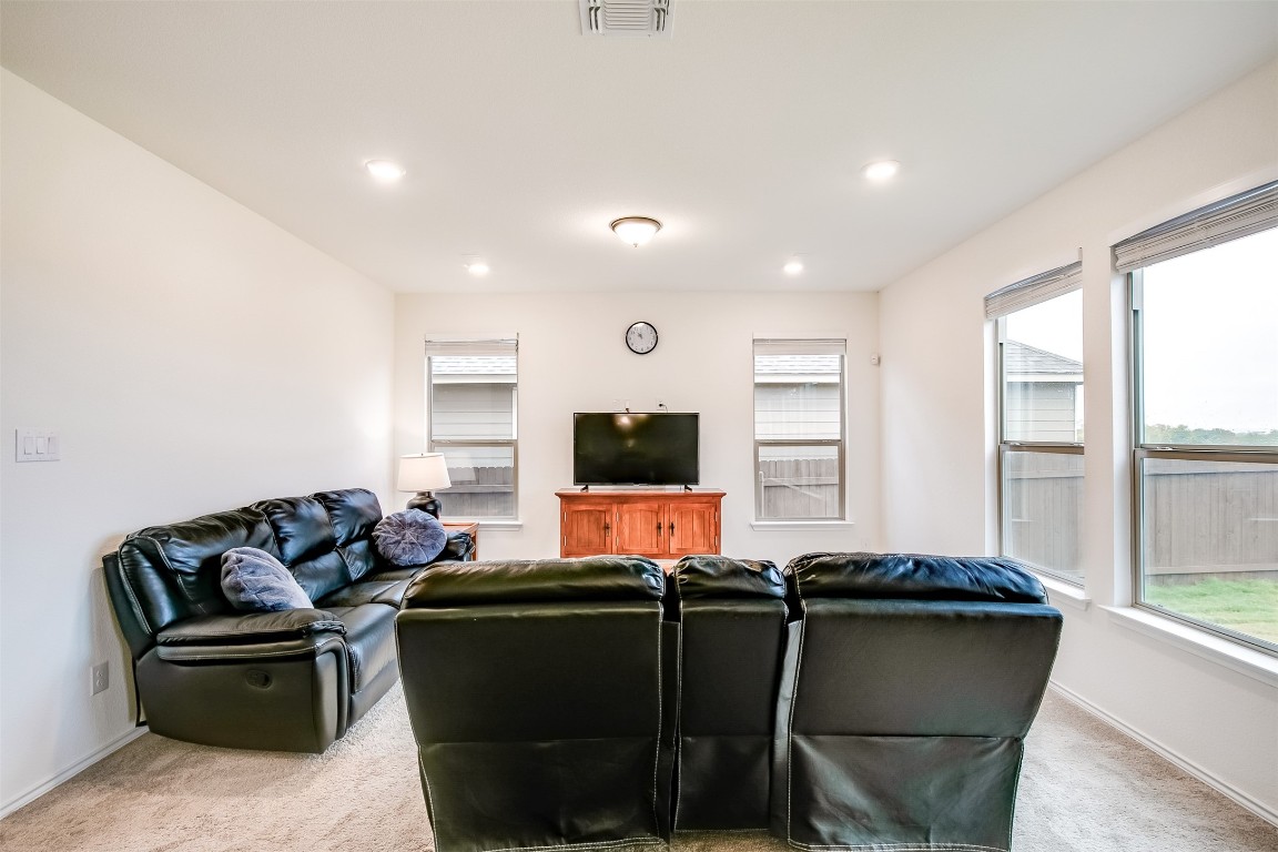 1924 Stringer Pass Leander, TX 78641 - Photo 12 of 34 a living room with furniture and a flat screen tv