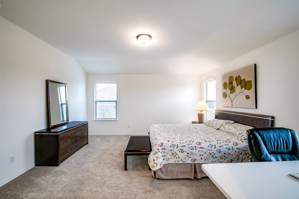1924 Stringer Pass Leander, TX 78641 - Photo 21 of 34 a bedroom with a bed and a flat screen tv