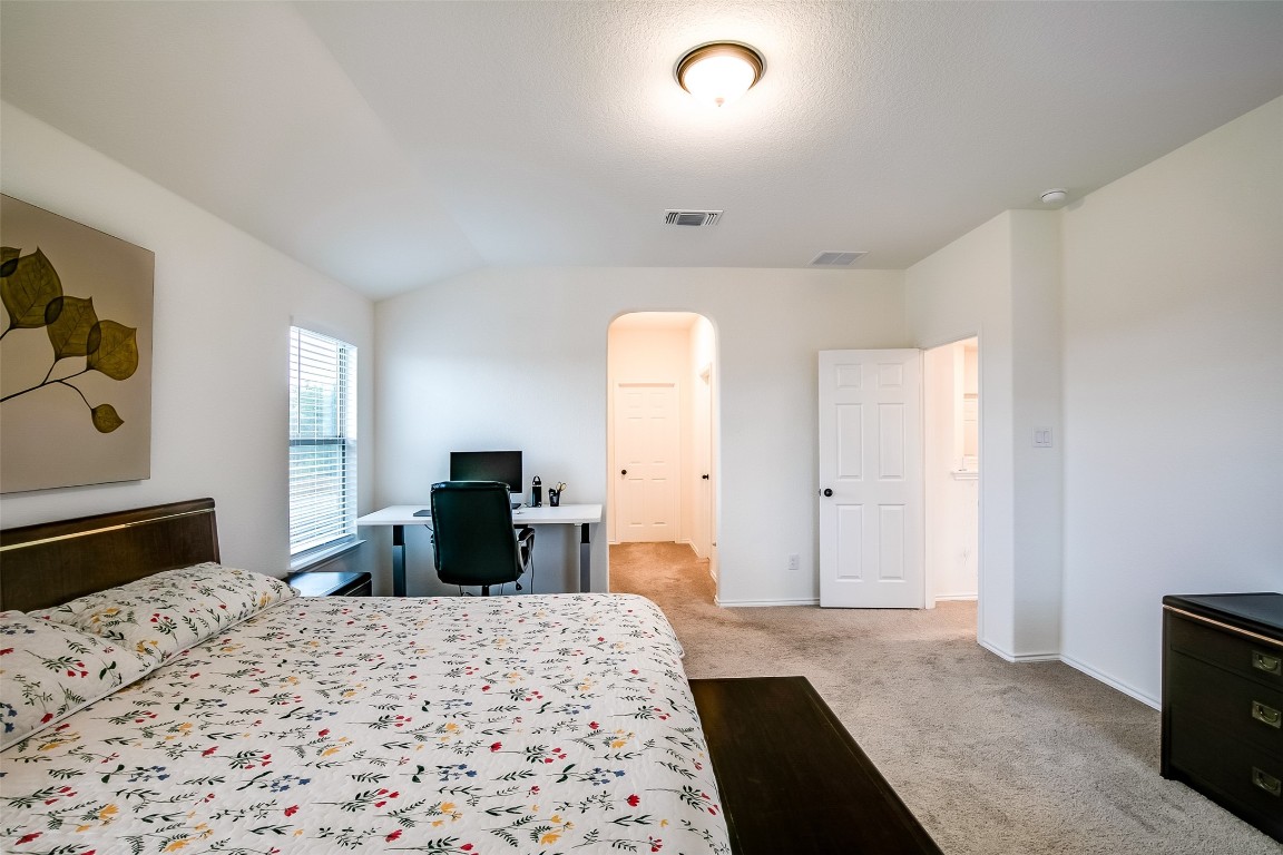 1924 Stringer Pass Leander, TX 78641 - Photo 23 of 34 a bedroom with a bed and a dresser