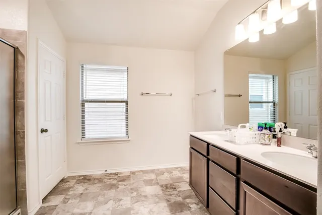 a bathroom with a sink vanity and a mirror
