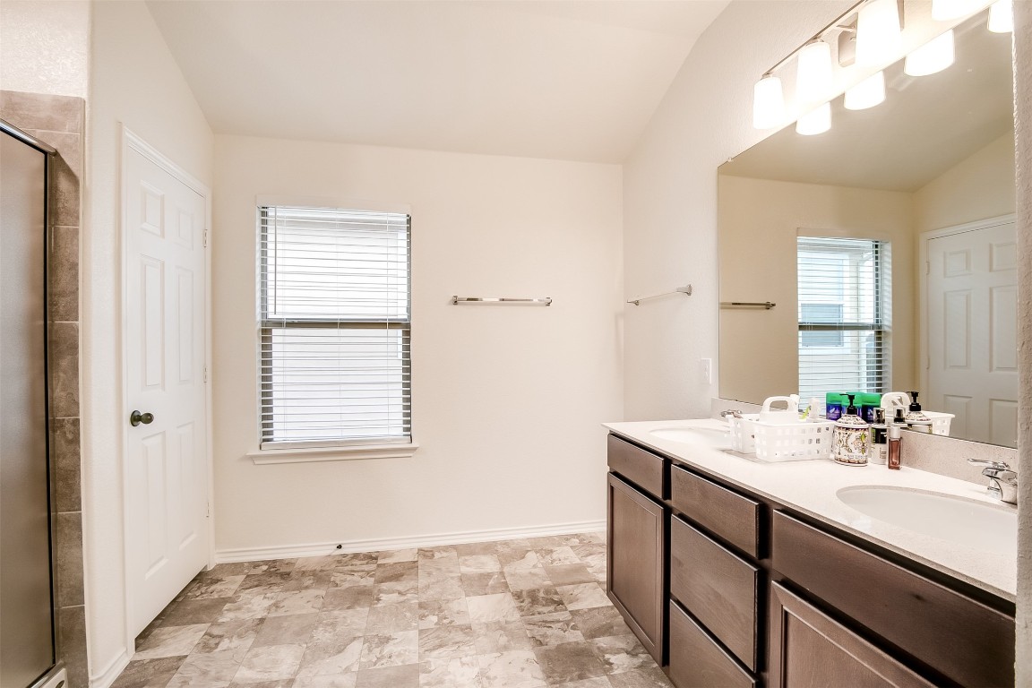1924 Stringer Pass Leander, TX 78641 - Photo 24 of 34 a bathroom with a sink vanity and a mirror