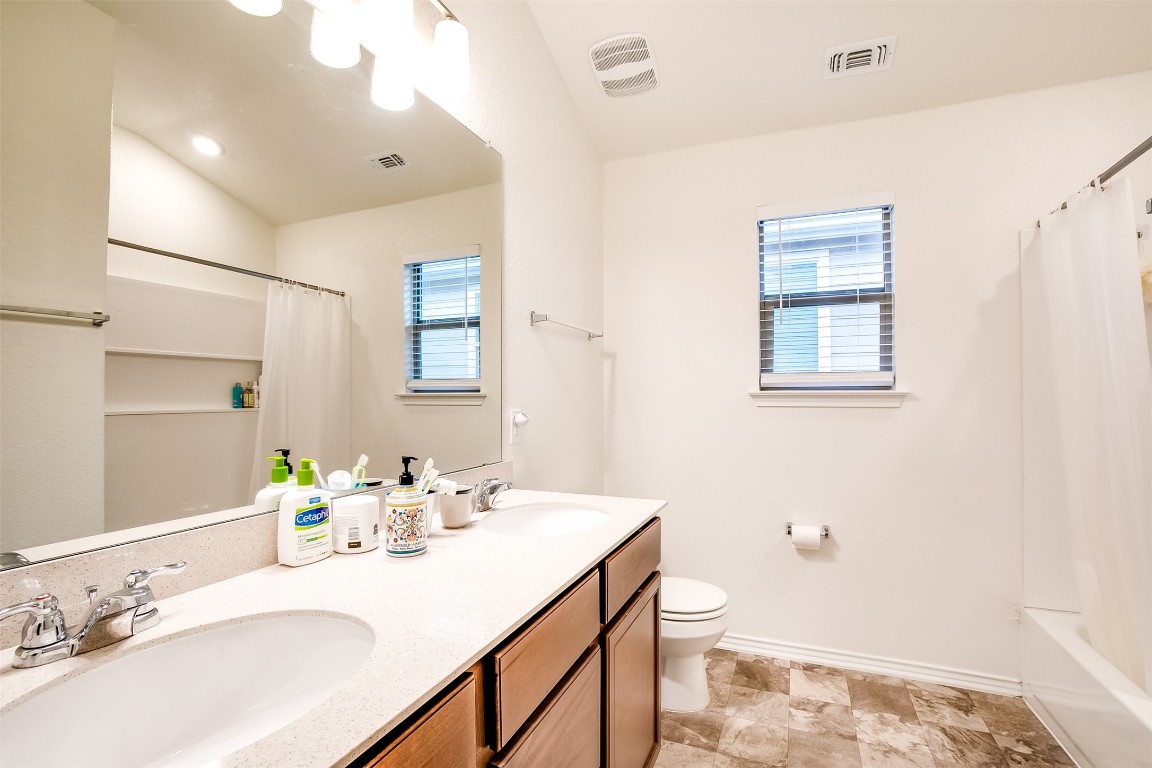 1924 Stringer Pass Leander, TX 78641 - Photo 27 of 34 a bathroom with a sink vanity granite and toilet
