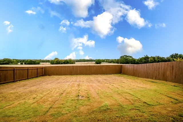 a view of swimming pool with outdoor seating and yard in back