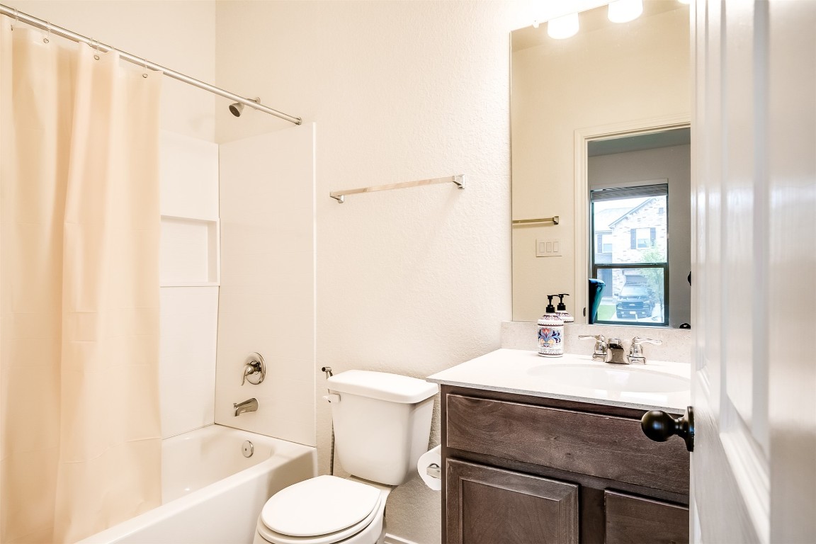 1924 Stringer Pass Leander, TX 78641 - Photo 6 of 34 a bathroom with a sink toilet and shower