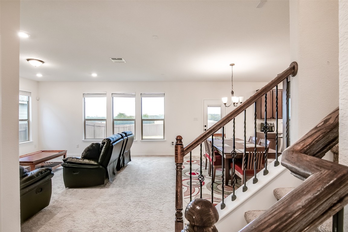 1924 Stringer Pass Leander, TX 78641 - Photo 7 of 34 a living room with furniture a flat screen tv and a large window