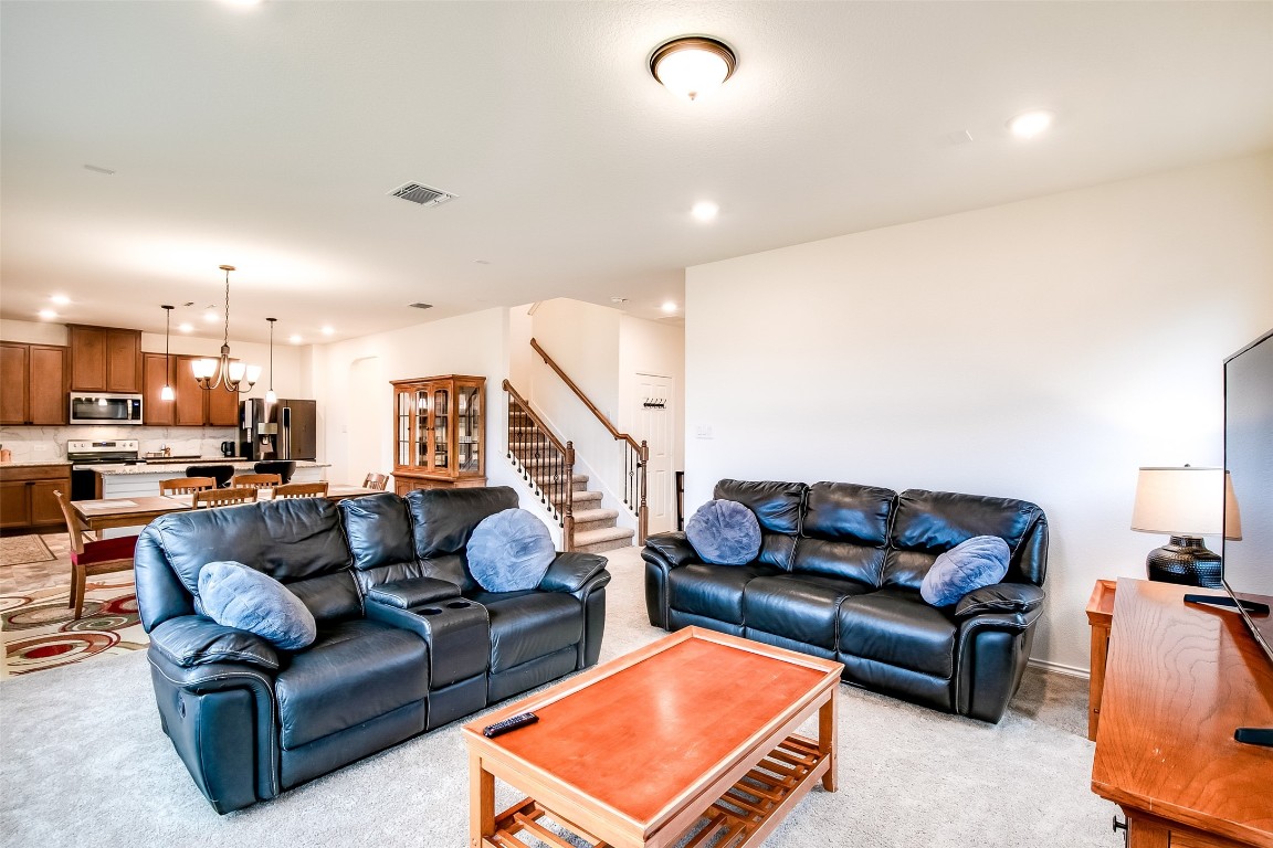 1924 Stringer Pass Leander, TX 78641 - Photo 10 of 34 a living room with furniture and a flat screen tv