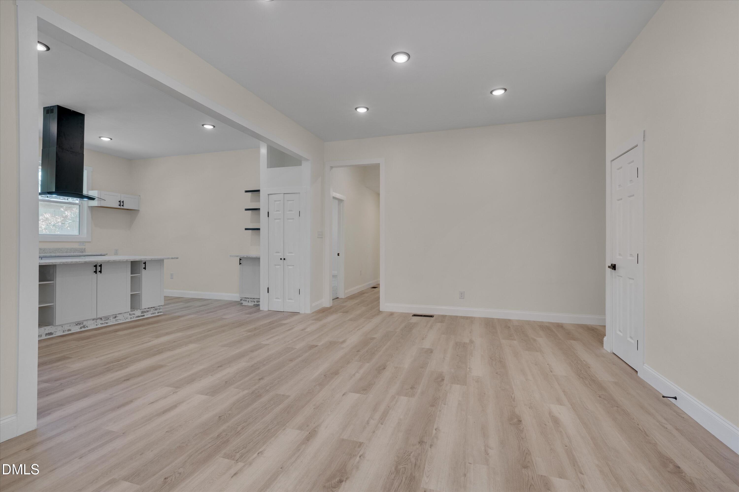 111 Virginia Avenue Roxboro, NC 27573 - Photo 12 of 42 an empty room with wooden floor and a sink