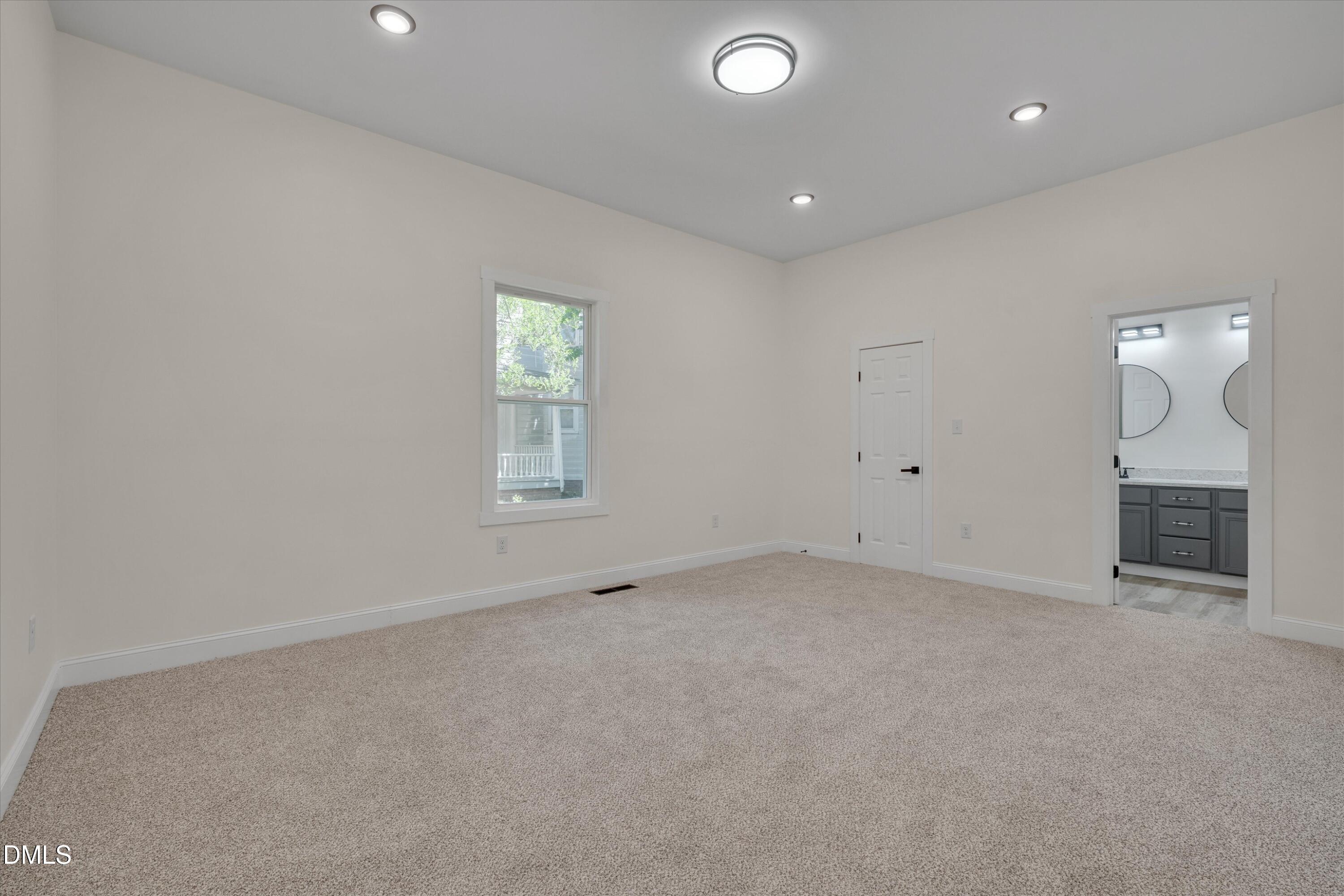 111 Virginia Avenue Roxboro, NC 27573 - Photo 18 of 42 an empty room with a fireplace and fan