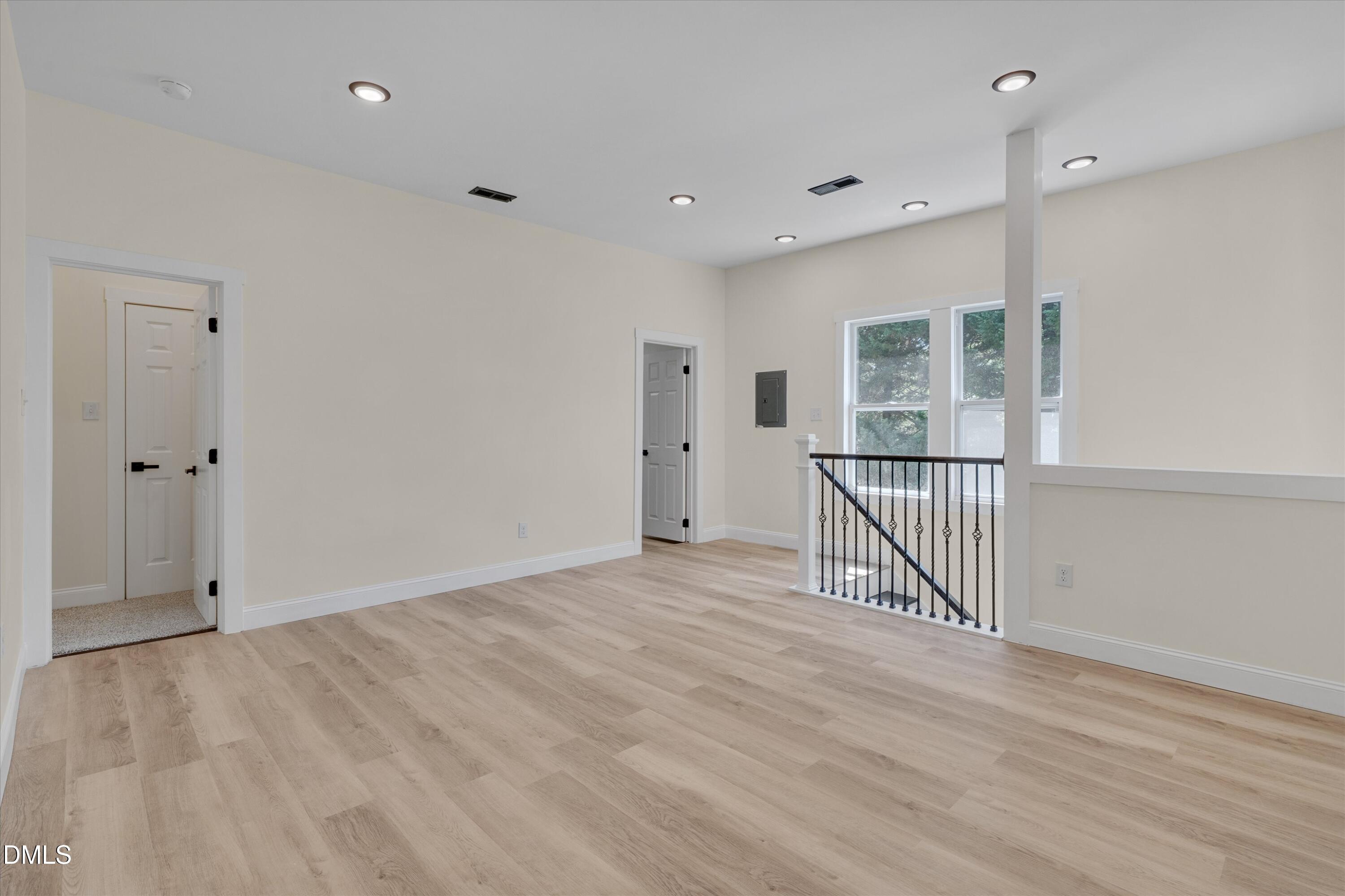 111 Virginia Avenue Roxboro, NC 27573 - Photo 24 of 42 an empty room with wooden floor and windows