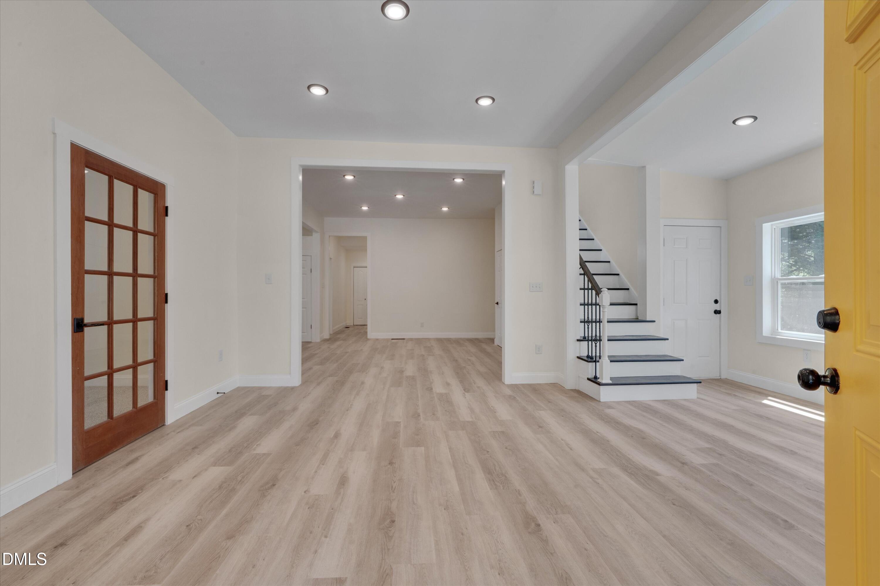 111 Virginia Avenue Roxboro, NC 27573 - Photo 6 of 42 a view of empty room with wooden floor and windows