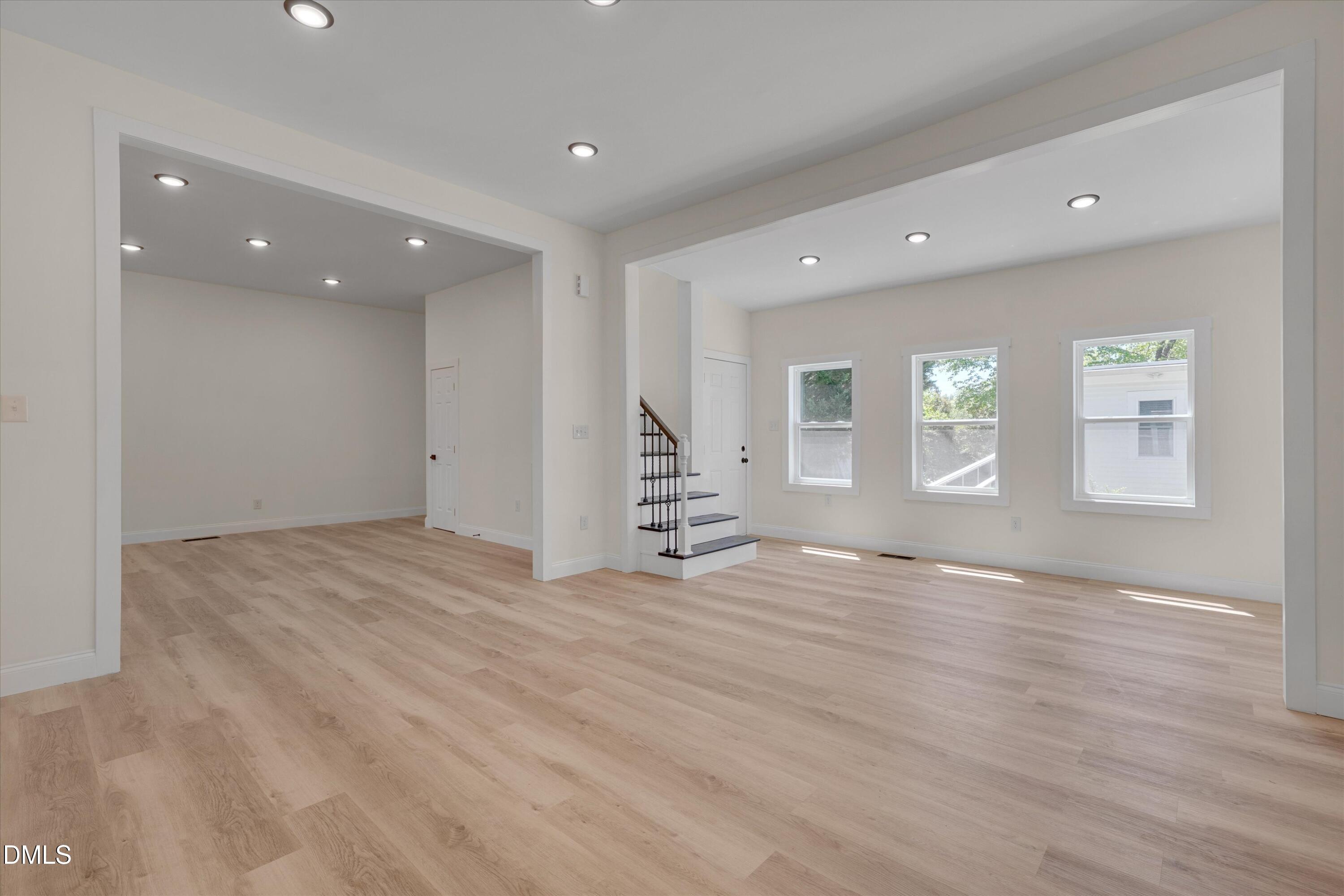 111 Virginia Avenue Roxboro, NC 27573 - Photo 7 of 42 an empty room with wooden floor and windows