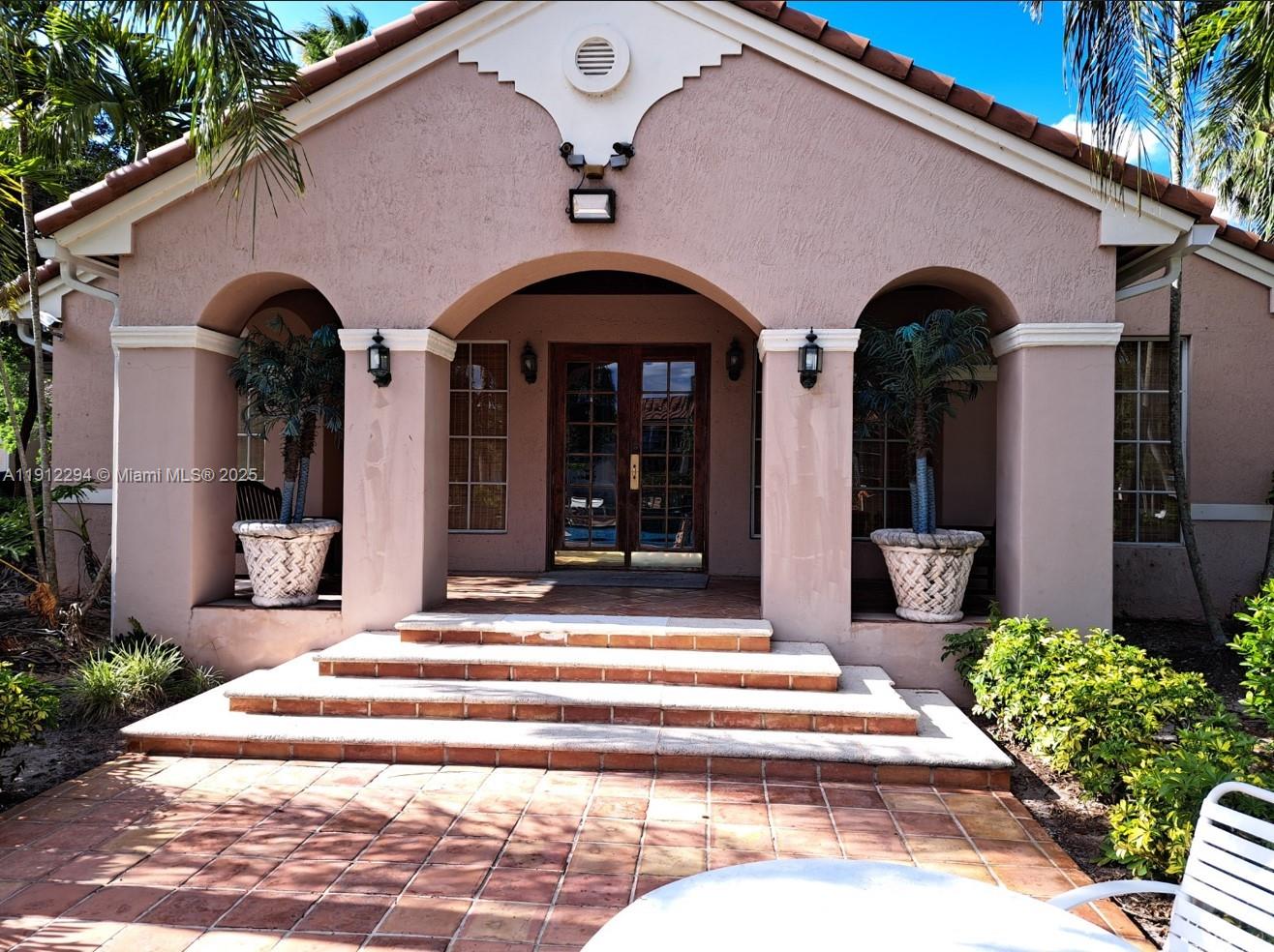 12136 St.Andrews Place, Unit 205 Miramar, FL 33025 - Photo 15 of 23 a couple of potted plants in front of a house