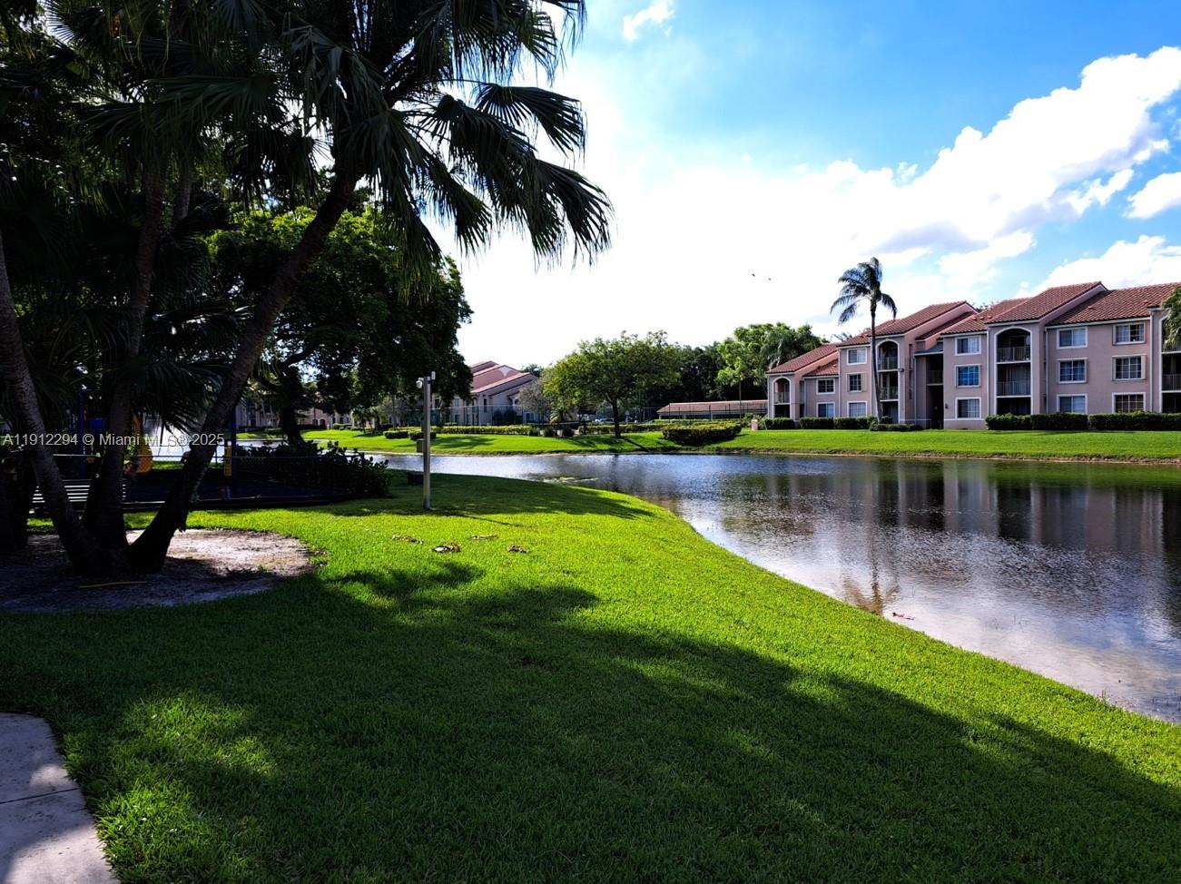 12136 St.Andrews Place, Unit 205 Miramar, FL 33025 - Photo 16 of 23 a view of a house with a yard