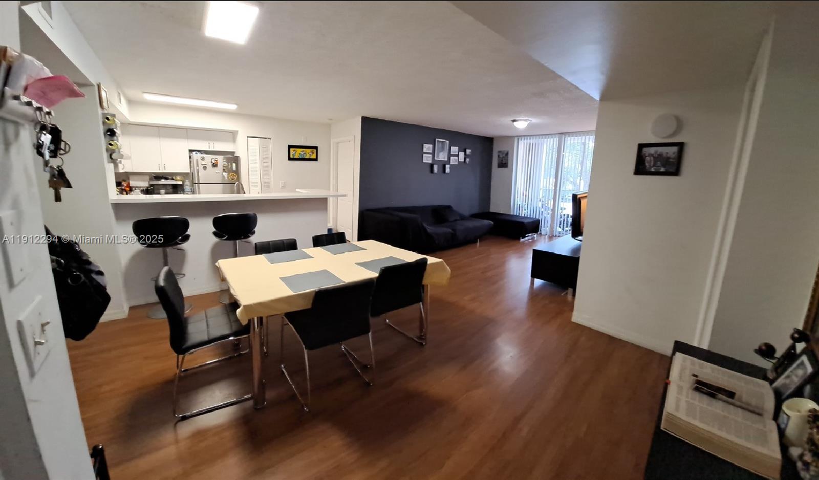 12136 St.Andrews Place, Unit 205 Miramar, FL 33025 - Photo 2 of 23 a living room with furniture wooden floor and a table