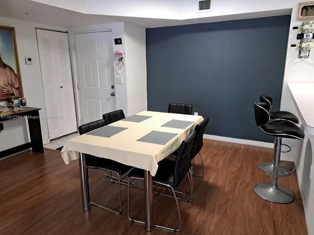 a view of a dining room with furniture and wooden floor