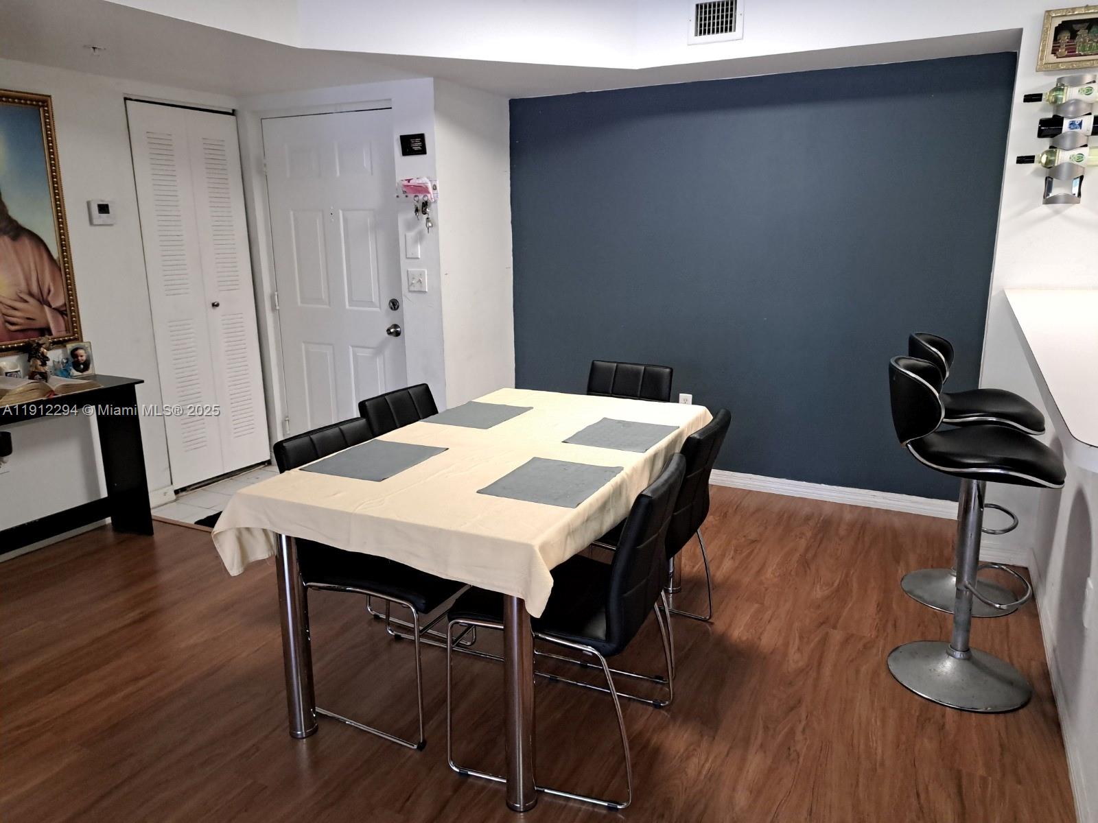 12136 St.Andrews Place, Unit 205 Miramar, FL 33025 - Photo 3 of 23 a view of a dining room with furniture and wooden floor