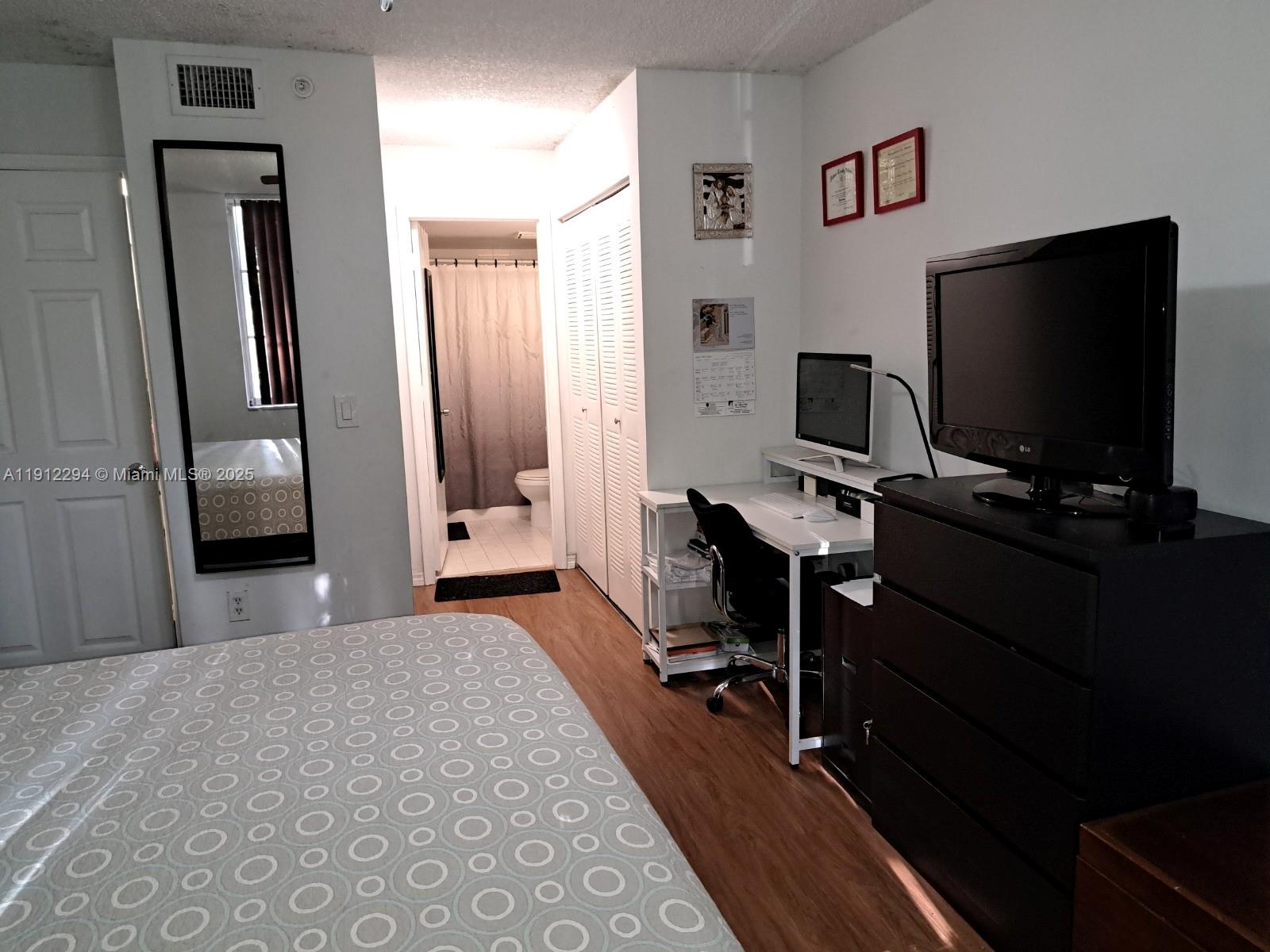 12136 St.Andrews Place, Unit 205 Miramar, FL 33025 - Photo 7 of 23 a view of a livingroom with furniture and a flat screen tv