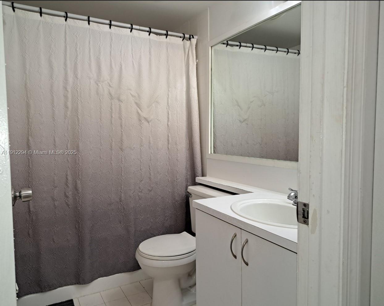 12136 St.Andrews Place, Unit 205 Miramar, FL 33025 - Photo 10 of 23 a bathroom with a sink a toilet and shower